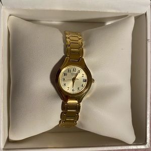 Citizen Women’s Watch. Gold stainless steel band with champagne face, 23mm.